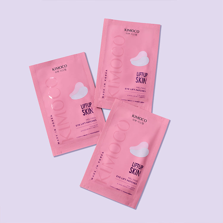 Różowe opakowanie "Kimoco Lift-Up Skin Melting Eye Lift Patches" z widocznym zdjęciem dwóch płatków pod oczy, na jasnoszarym tle.